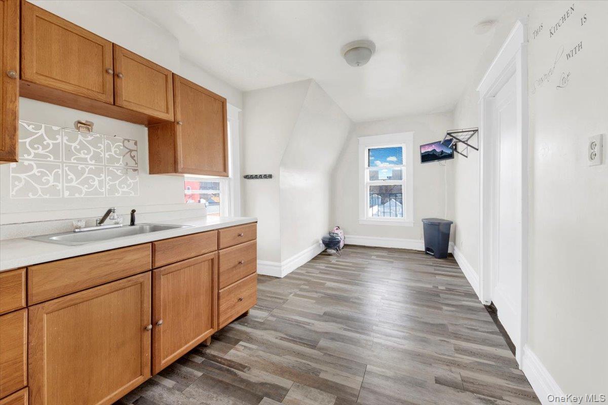 2312 Morgan Avenue Bronx, NY 10469 - Photo 18 of 36 Kitchen with light countertops, dark wood-type flooring, and brown cabinetry