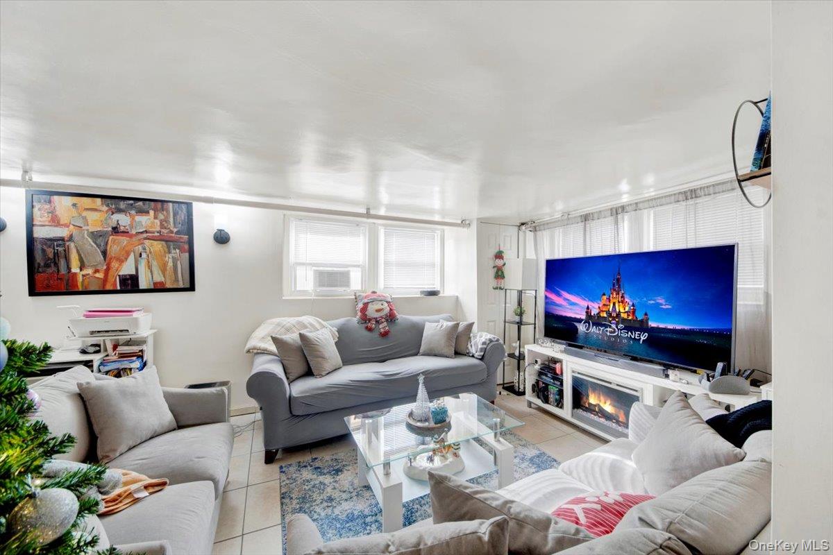 2312 Morgan Avenue Bronx, NY 10469 - Photo 28 of 36 Living room featuring tile patterned floors and a glass covered fireplace