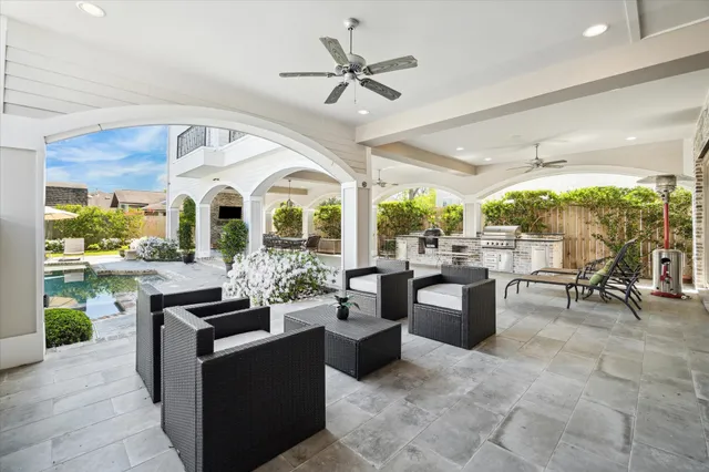 a living room with fireplace furniture and a large window
