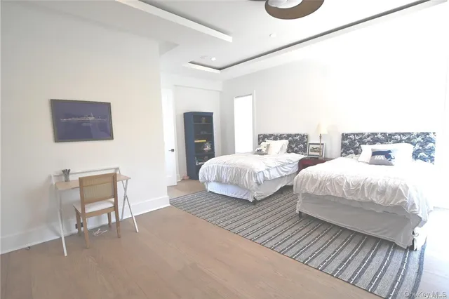 a bedroom with two beds and a chair