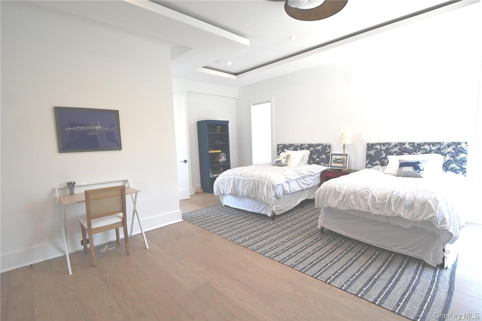 43 Smugglers Path Riverhead, NY 11901 - Photo 11 of 17 a bedroom with two beds and a chair