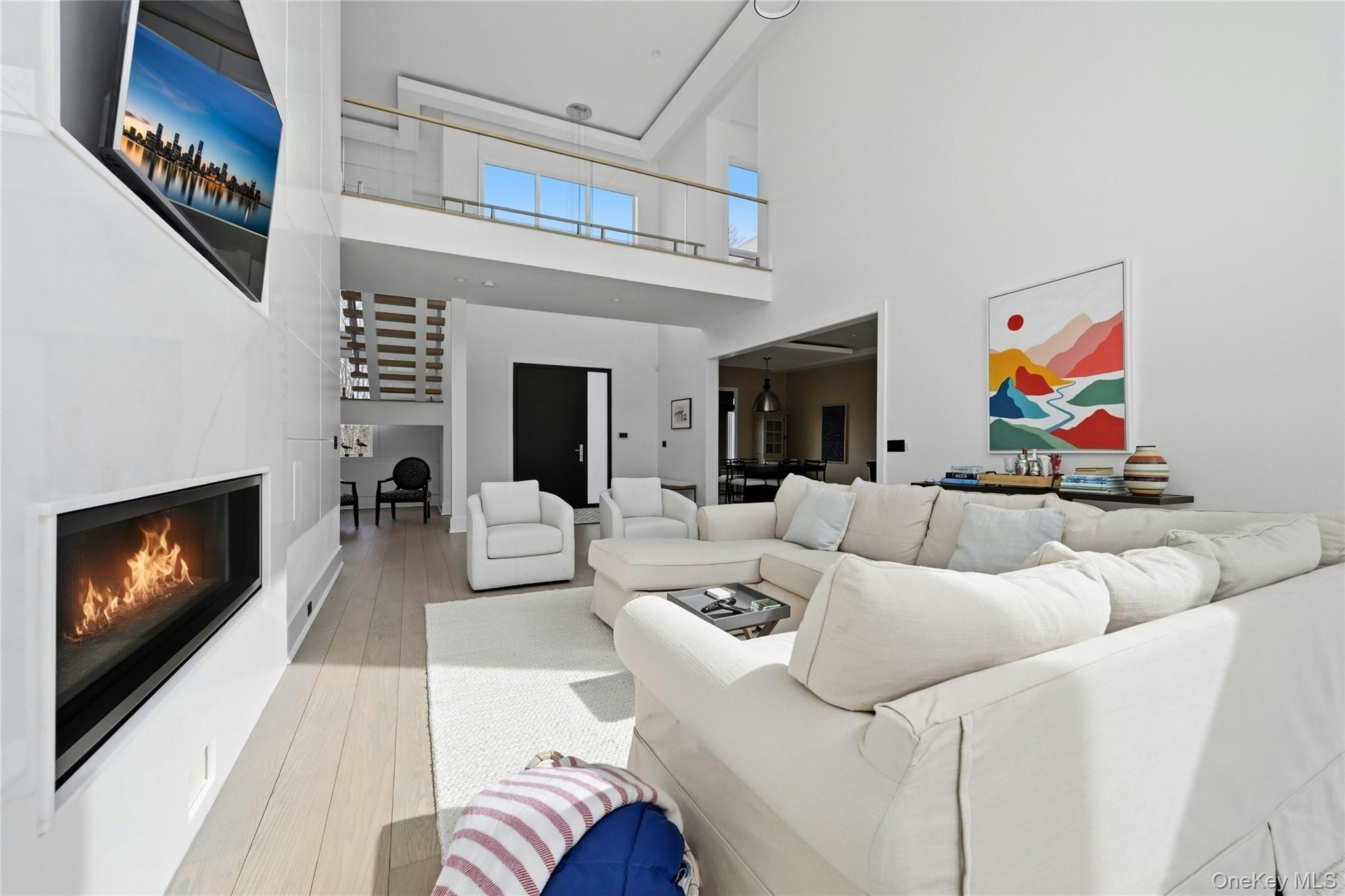 43 Smugglers Path Riverhead, NY 11901 - Photo 11 of 37 a living room with furniture a fireplace and a flat screen tv