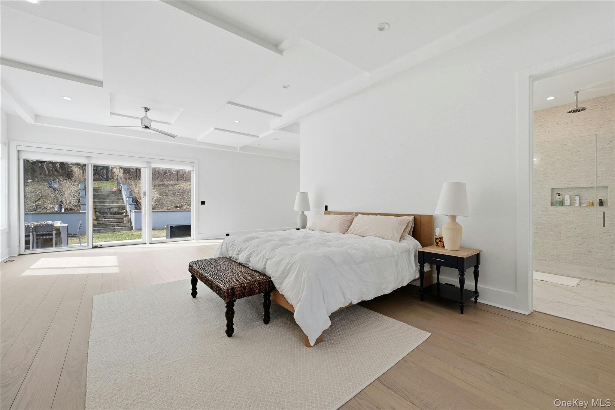 43 Smugglers Path Riverhead, NY 11901 - Photo 12 of 37 a spacious bedroom with a bed and a large window