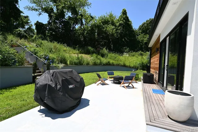 a view of a backyard with garden and patio