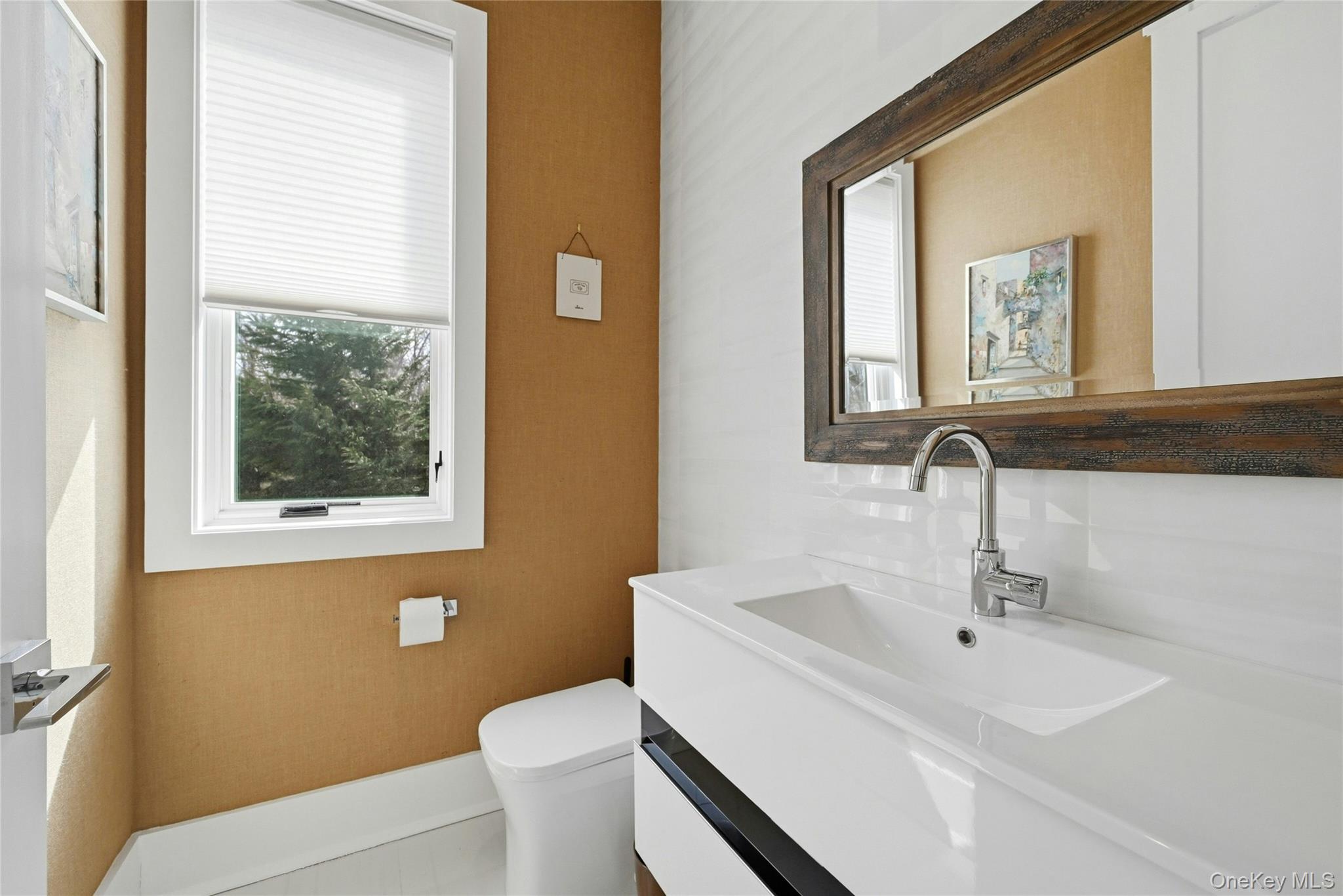 43 Smugglers Path Riverhead, NY 11901 - Photo 16 of 37 a bathroom with a sink a toilet and a mirror