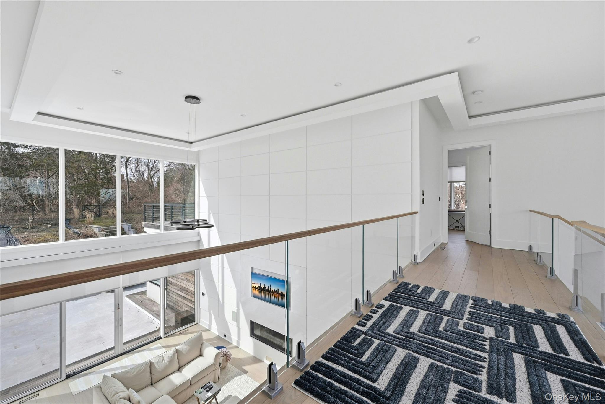 43 Smugglers Path Riverhead, NY 11901 - Photo 17 of 37 a view of an empty room with wooden floor and windows