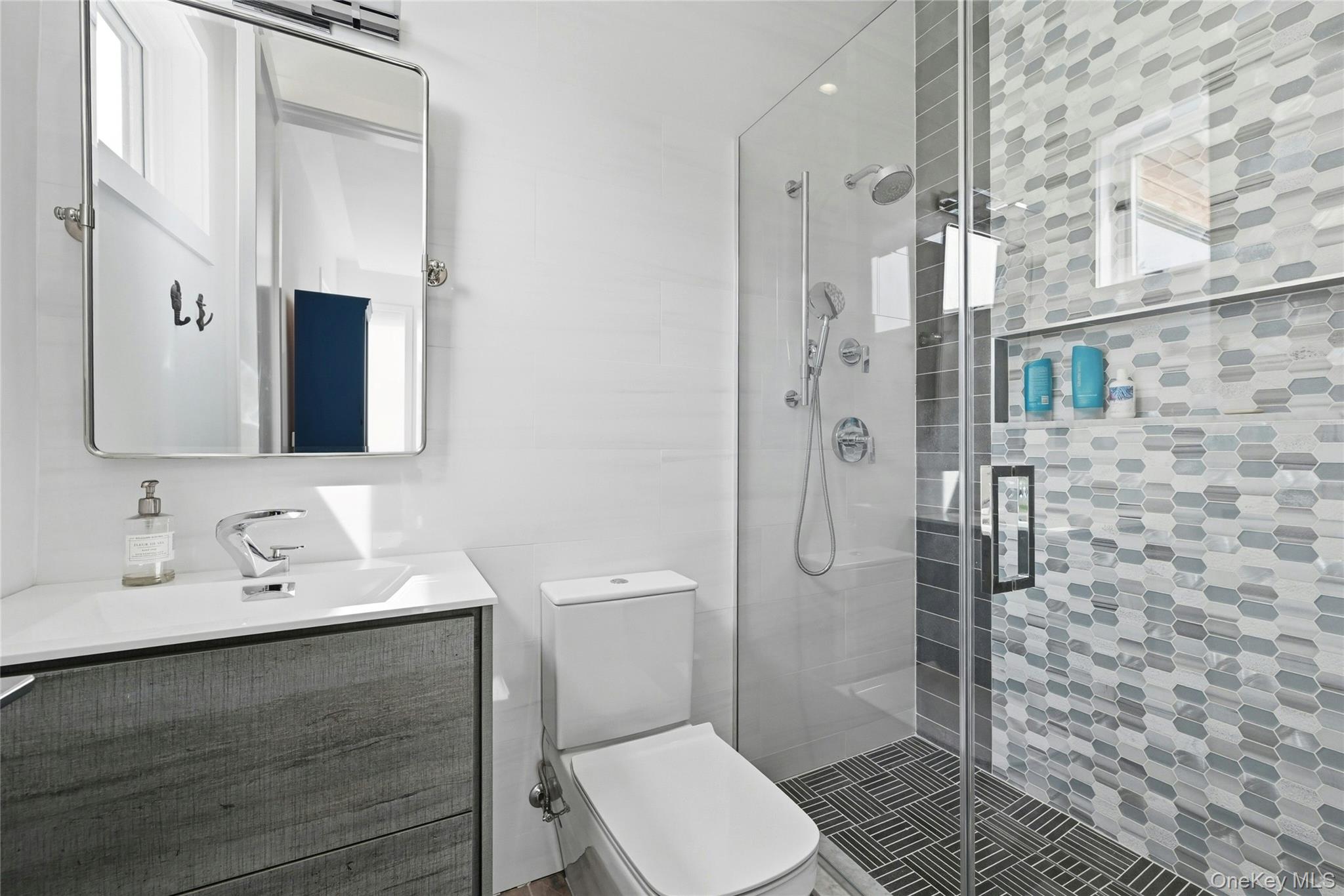 43 Smugglers Path Riverhead, NY 11901 - Photo 19 of 37 a bathroom with a sink a toilet and shower