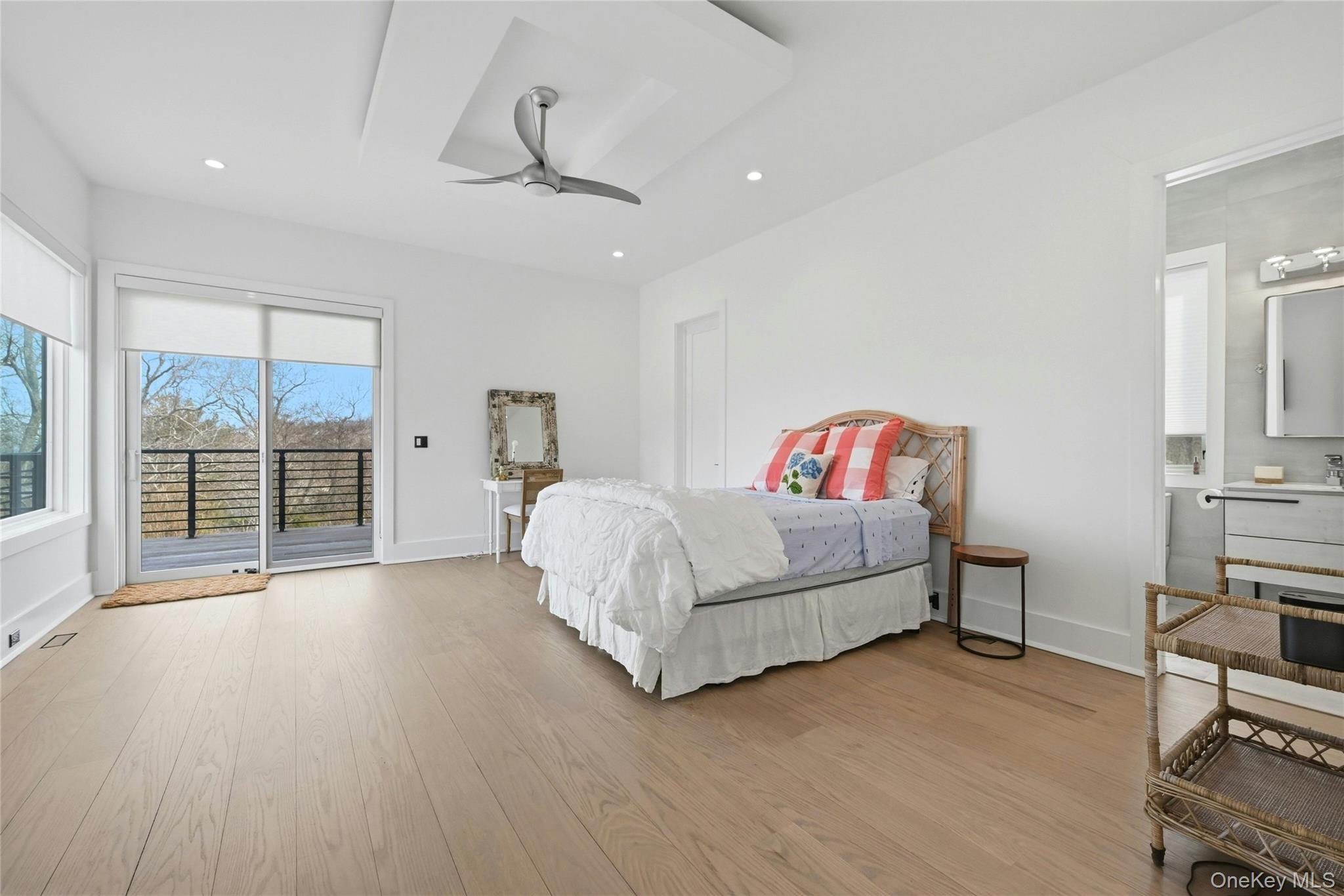 43 Smugglers Path Riverhead, NY 11901 - Photo 20 of 37 a spacious bedroom with a bed and a large window