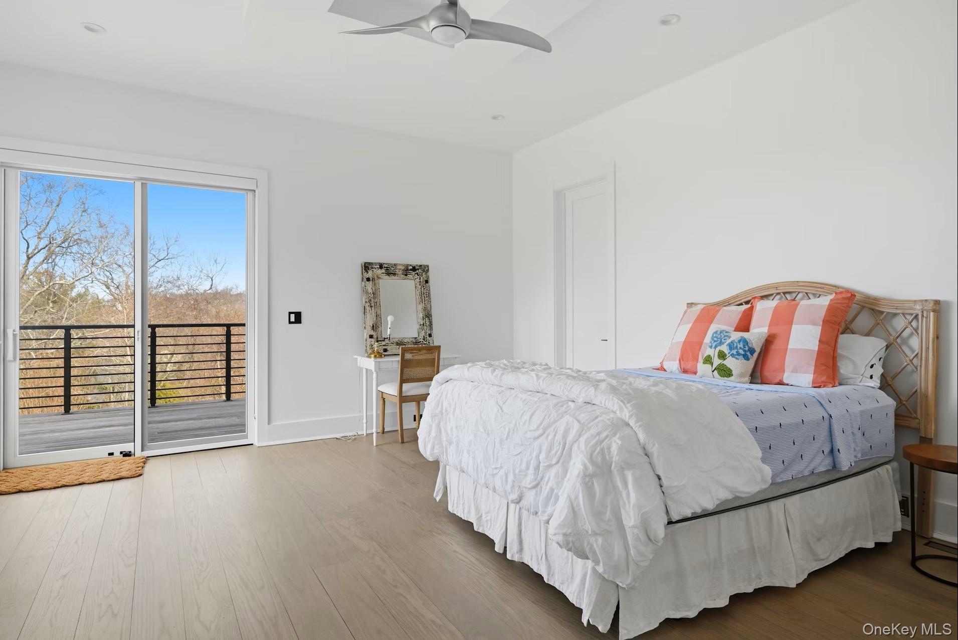 43 Smugglers Path Riverhead, NY 11901 - Photo 21 of 37 a bedroom with a bed and a large window