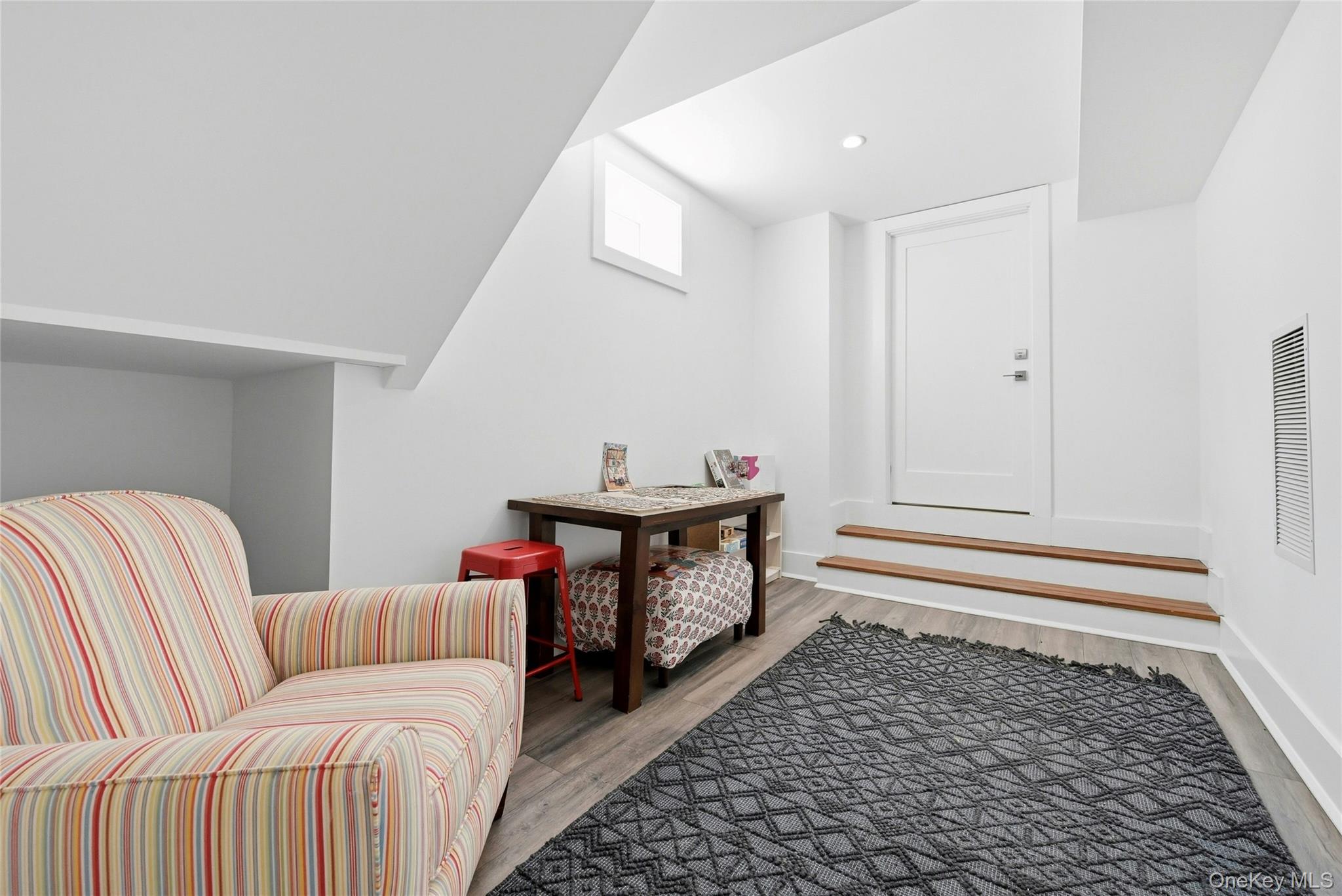 43 Smugglers Path Riverhead, NY 11901 - Photo 24 of 37 a living room with furniture and a rug