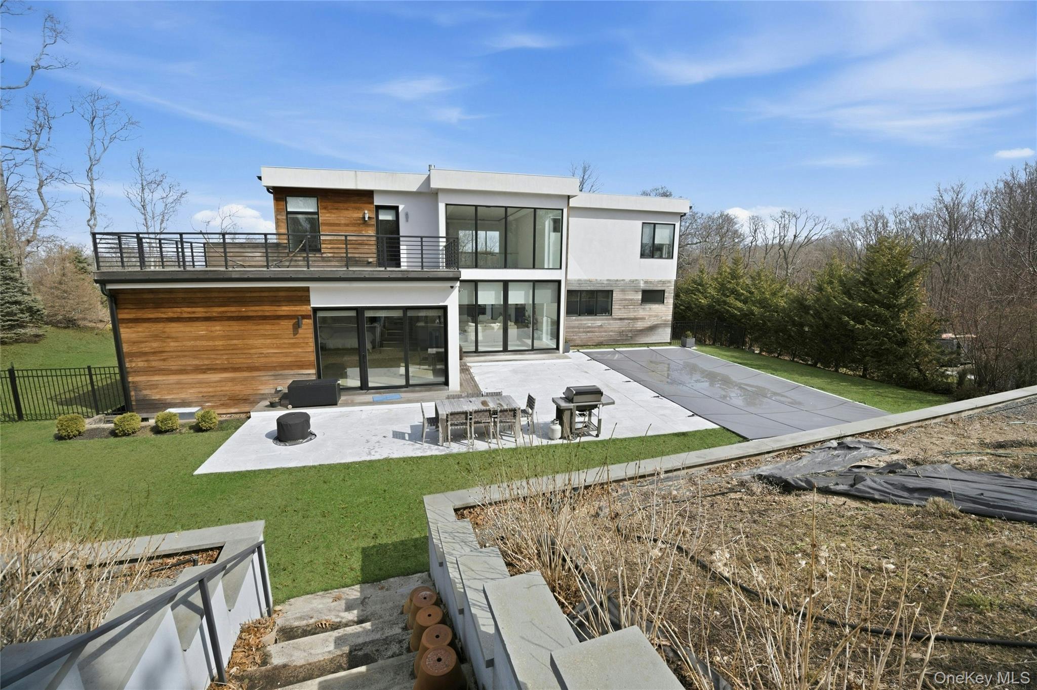 43 Smugglers Path Riverhead, NY 11901 - Photo 27 of 37 a view of a house with backyard sitting area and swimming pool