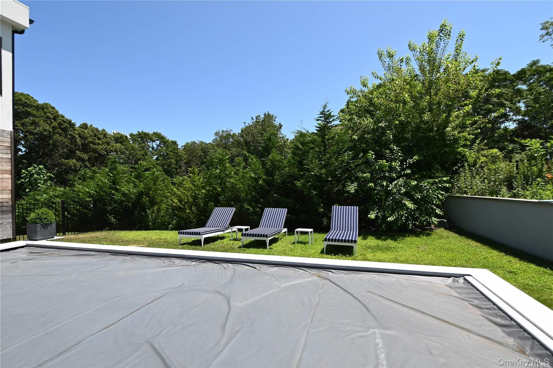 43 Smugglers Path Riverhead, NY 11901 - Photo 29 of 37 a small garden with trees in the background