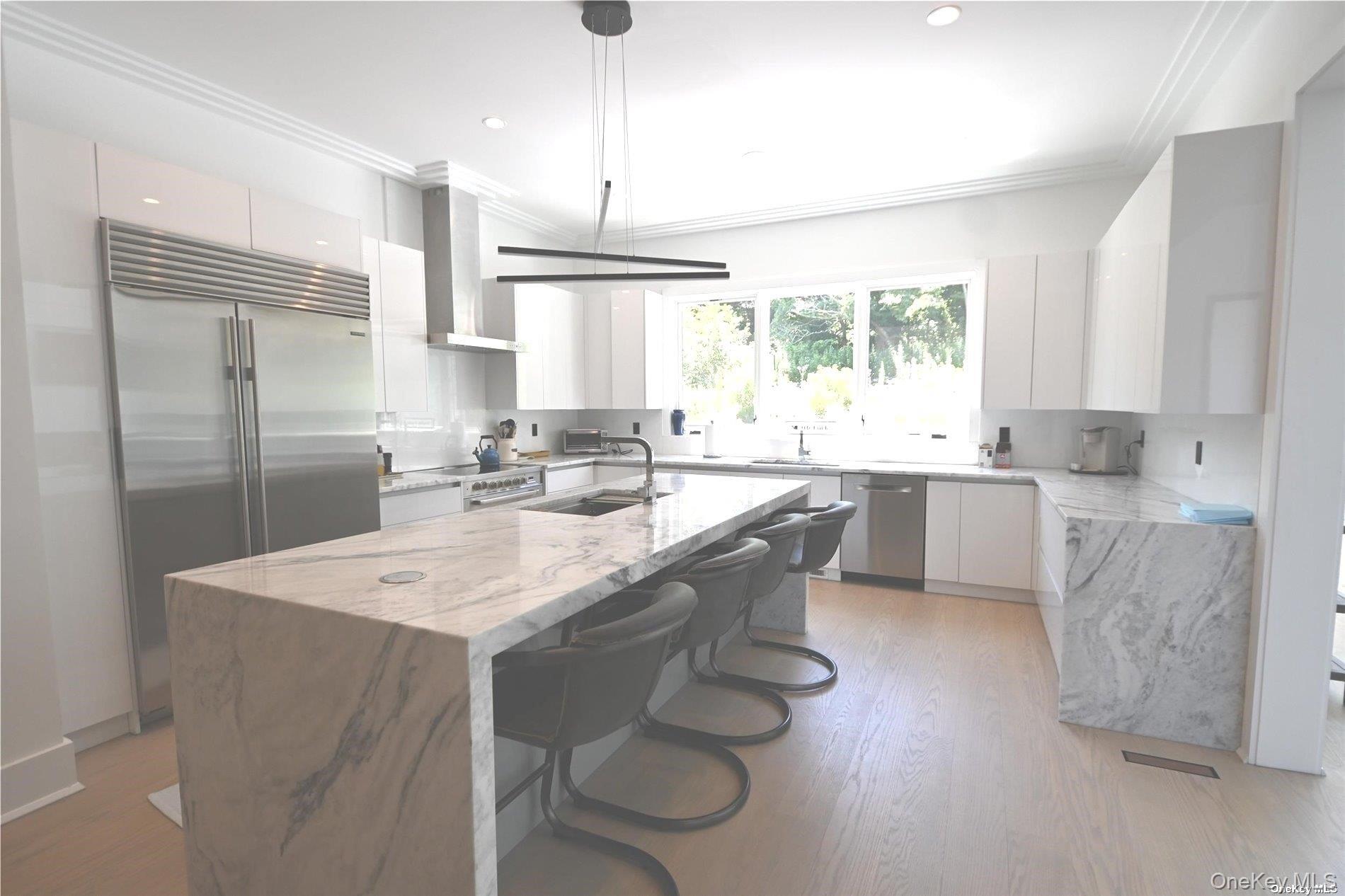 43 Smugglers Path Riverhead, NY 11901 - Photo 3 of 17 a large kitchen with kitchen island a sink stainless steel appliances and cabinets