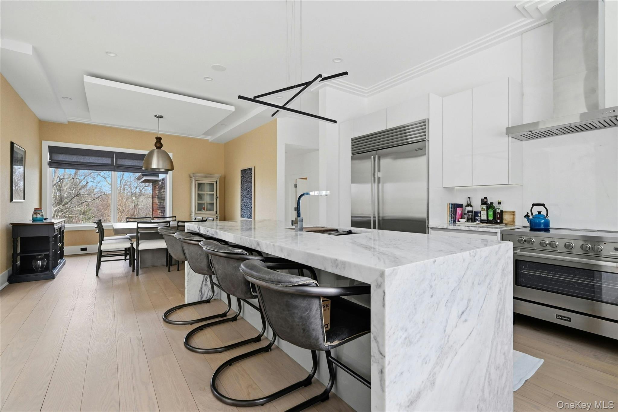 43 Smugglers Path Riverhead, NY 11901 - Photo 5 of 37 a kitchen with furniture a counter top space and stainless steel appliances
