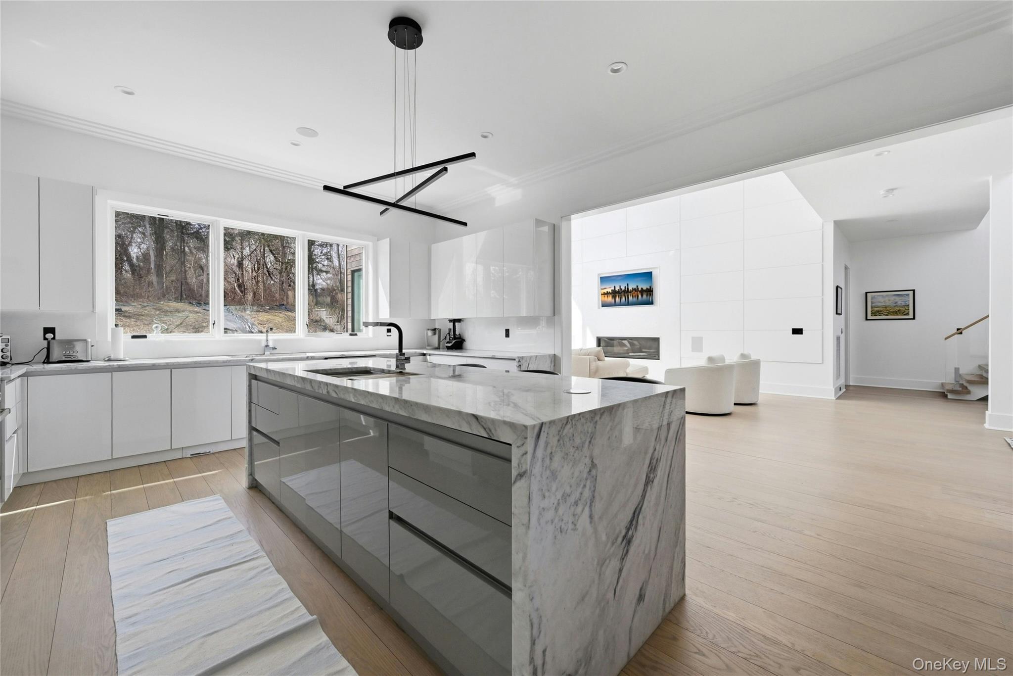 43 Smugglers Path Riverhead, NY 11901 - Photo 6 of 37 a large kitchen with granite countertop a sink and dishwasher a stove with wooden floor