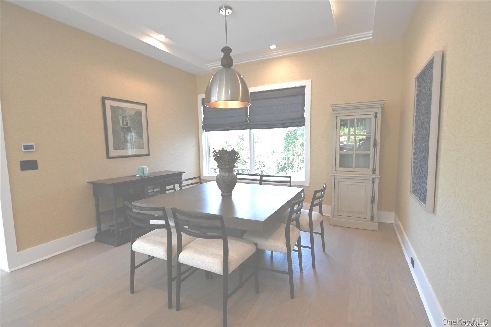 43 Smugglers Path Riverhead, NY 11901 - Photo 6 of 17 a view of a dining room with furniture window and wooden floor
