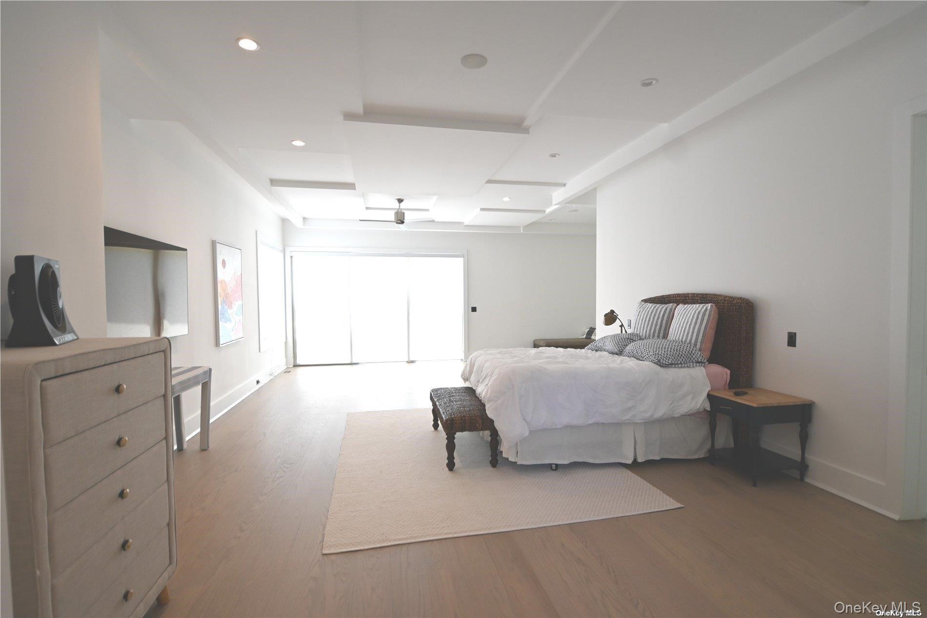 43 Smugglers Path Riverhead, NY 11901 - Photo 7 of 17 a spacious bedroom with a bed and a lamp