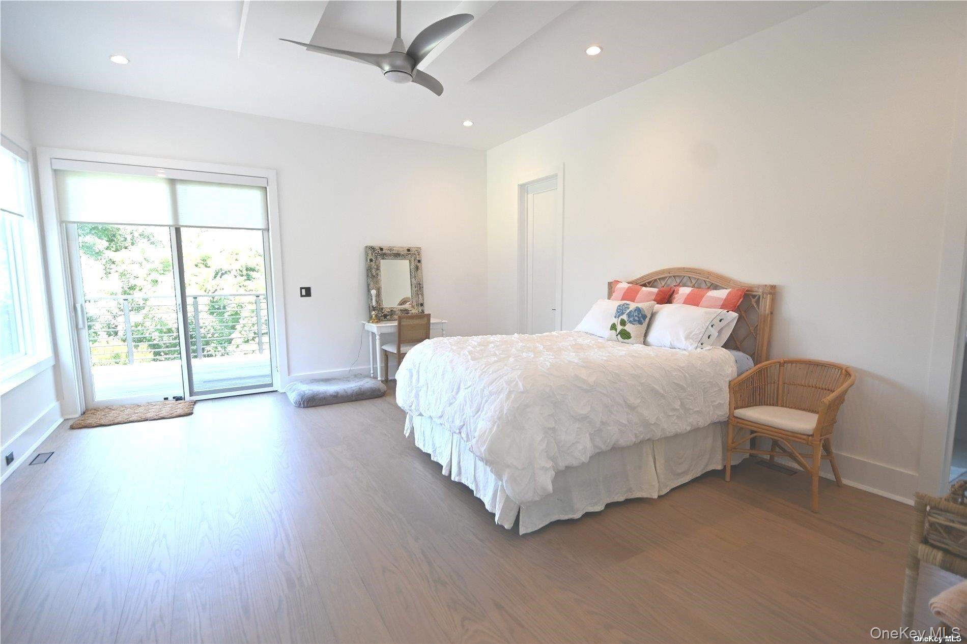 43 Smugglers Path Riverhead, NY 11901 - Photo 10 of 17 a spacious bedroom with a bed and a large window