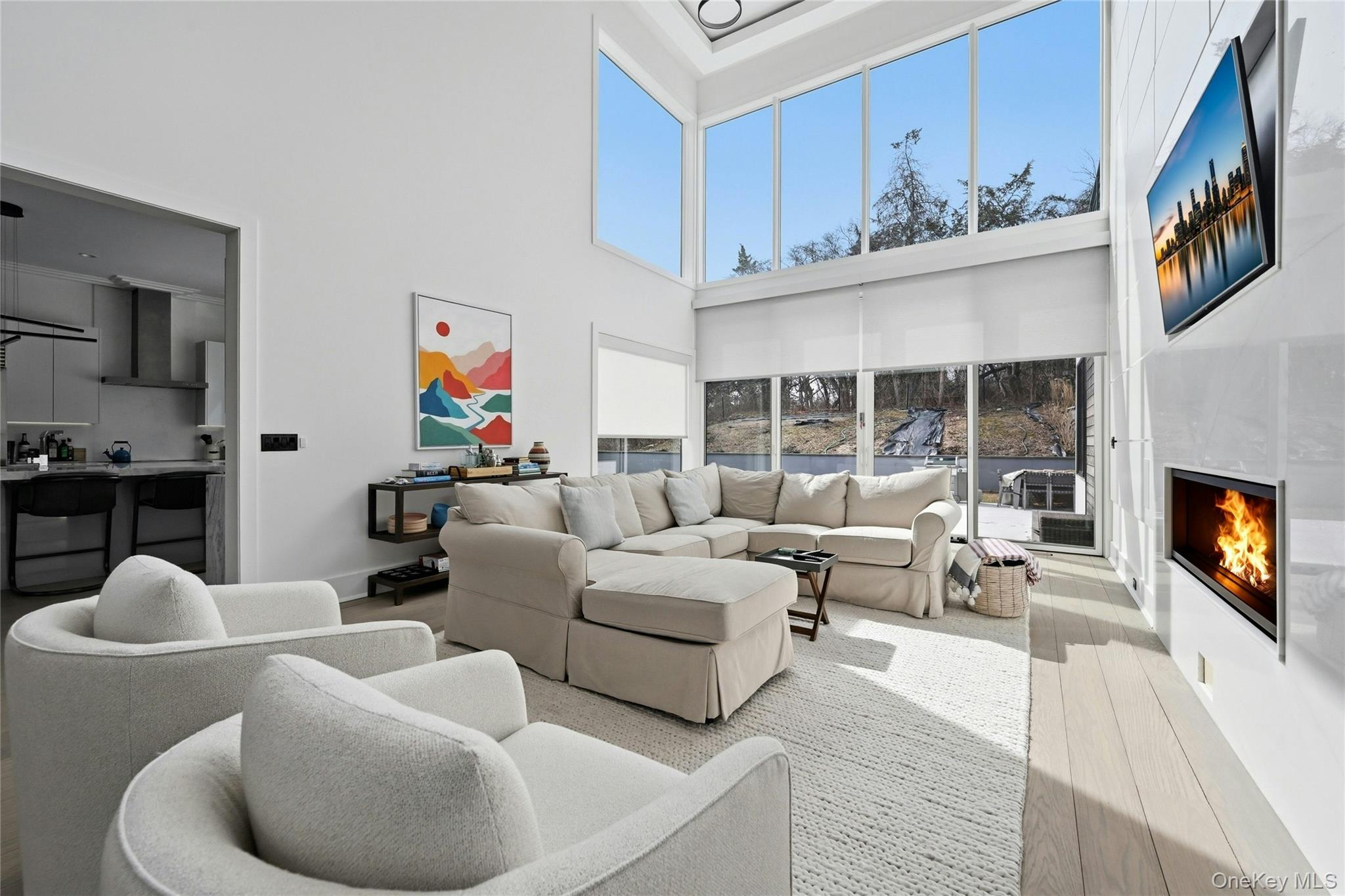 43 Smugglers Path Riverhead, NY 11901 - Photo 10 of 37 a living room with furniture a fireplace and a flat screen tv