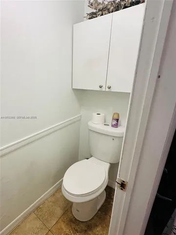 a white toilet sitting next to a sink