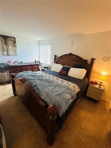 a bedroom with bed and window