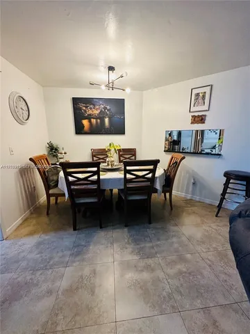 a living room with furniture and a lamp