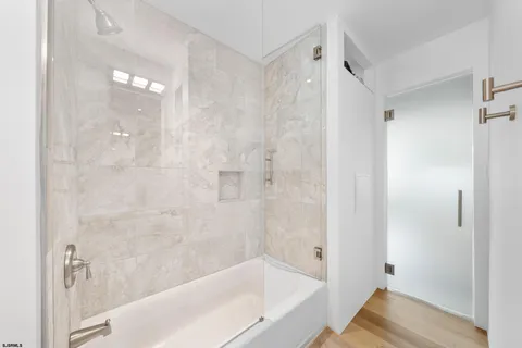 a bathroom with a bathtub and shower