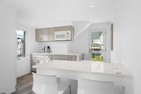 a kitchen with a sink cabinets and wooden floor