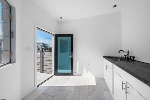 a hallway with sink and mirror
