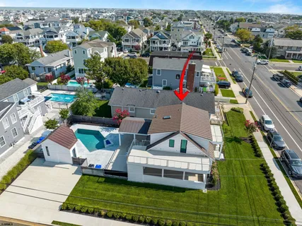 an aerial view of a house with a garden and lake view