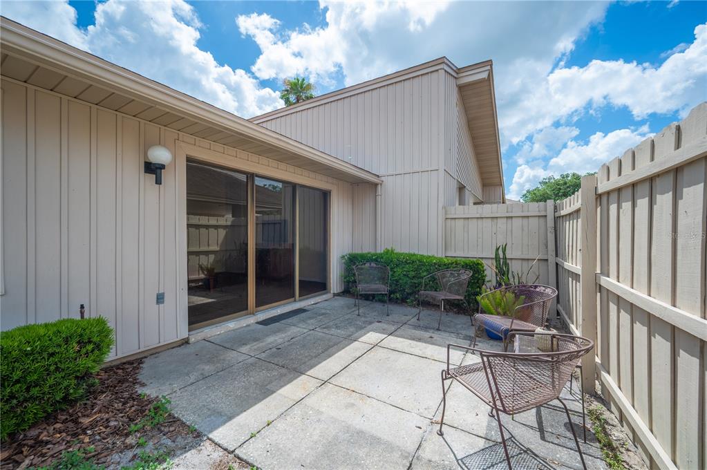 4231 Oak Loop, Unit 51 Mulberry, FL 33860 - Photo 24 of 29 a view of backyard with a chair and potted plants
