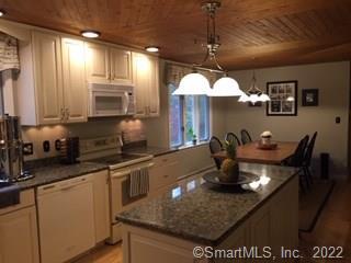 178 Burlington Road Harwinton, CT 06791 - Photo 1 of 1 a kitchen with stainless steel appliances granite countertop a sink dishwasher a stove a dining table and chairs with wooden floor