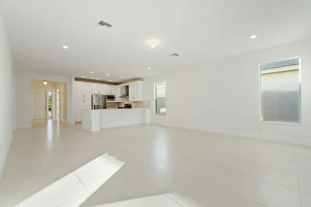 a view of a living room a kitchen and a livingroom with furniture