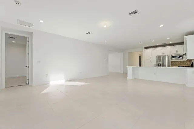 a view of a kitchen with white cabinets