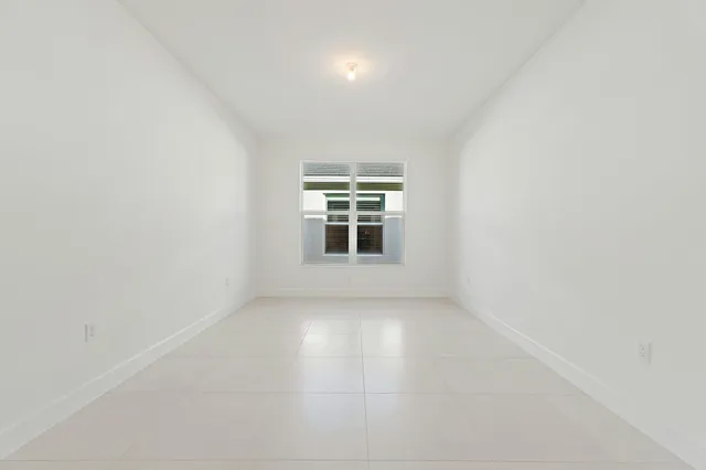 an empty room with windows and entrance