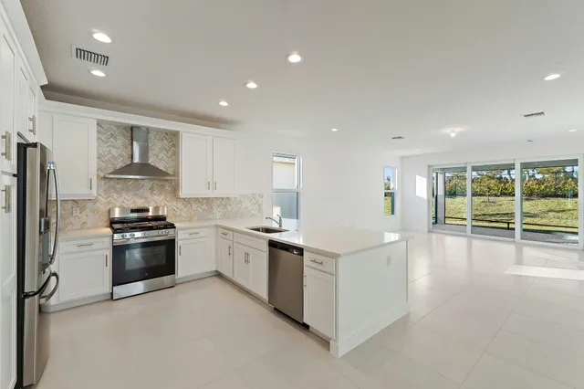 a kitchen with stainless steel appliances and white cabinets