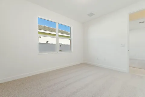 a bathroom with a granite countertop sink a toilet and a mirror