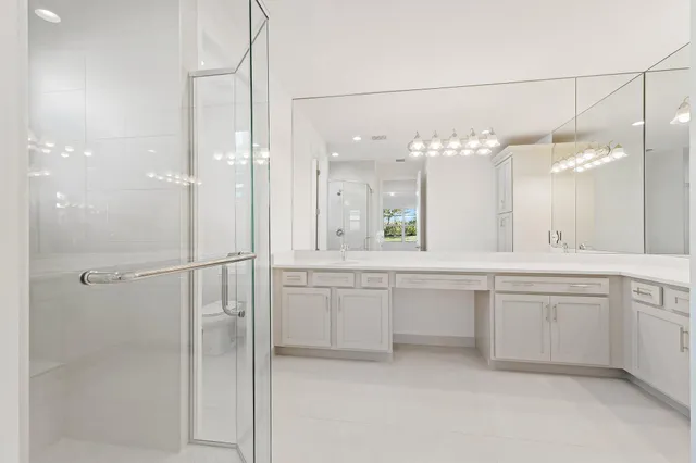 a large bathroom with a granite countertop sink mirror and a shower