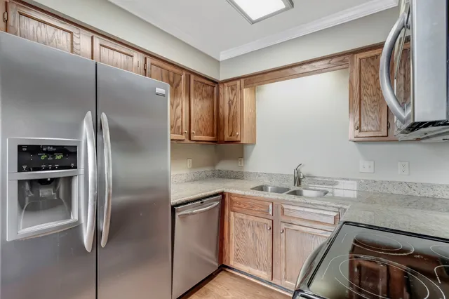 a kitchen with a refrigerator sink and microwave