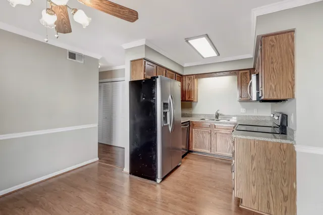 a kitchen with a refrigerator and a sink