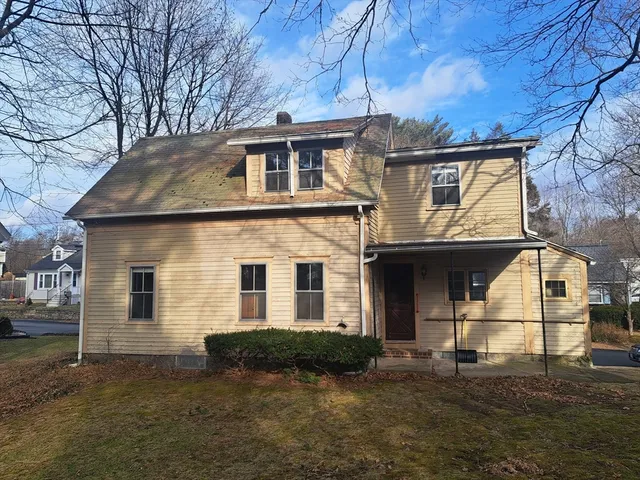 a view of a white house with a yard