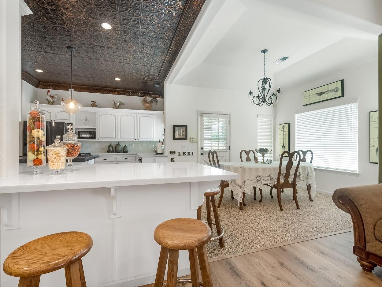 602 Fallbrook Avenue Clovis, CA 93611 - Photo 11 of 51 a kitchen with a dining table chairs sink and wooden floor