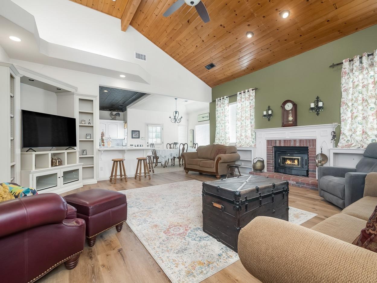 602 Fallbrook Avenue Clovis, CA 93611 - Photo 15 of 51 a living room with furniture a flat screen tv and a fireplace
