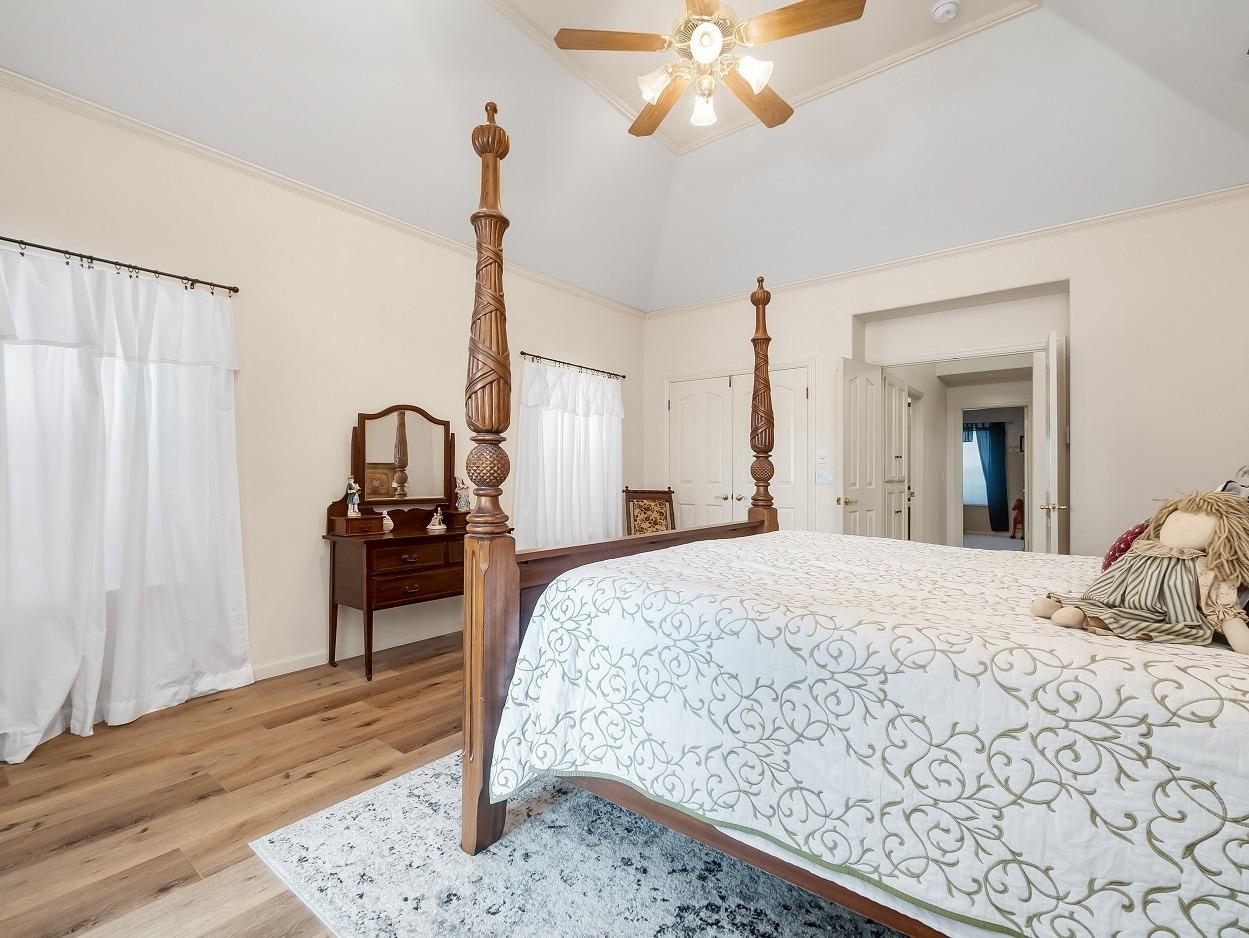 602 Fallbrook Avenue Clovis, CA 93611 - Photo 22 of 51 a bedroom with a bed and a chandelier