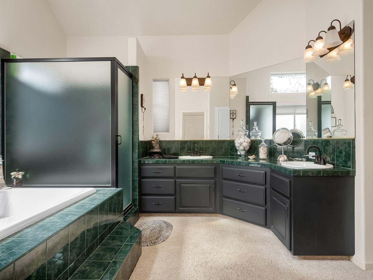 602 Fallbrook Avenue Clovis, CA 93611 - Photo 24 of 51 a bathroom with a granite countertop sink mirror and a bathtub