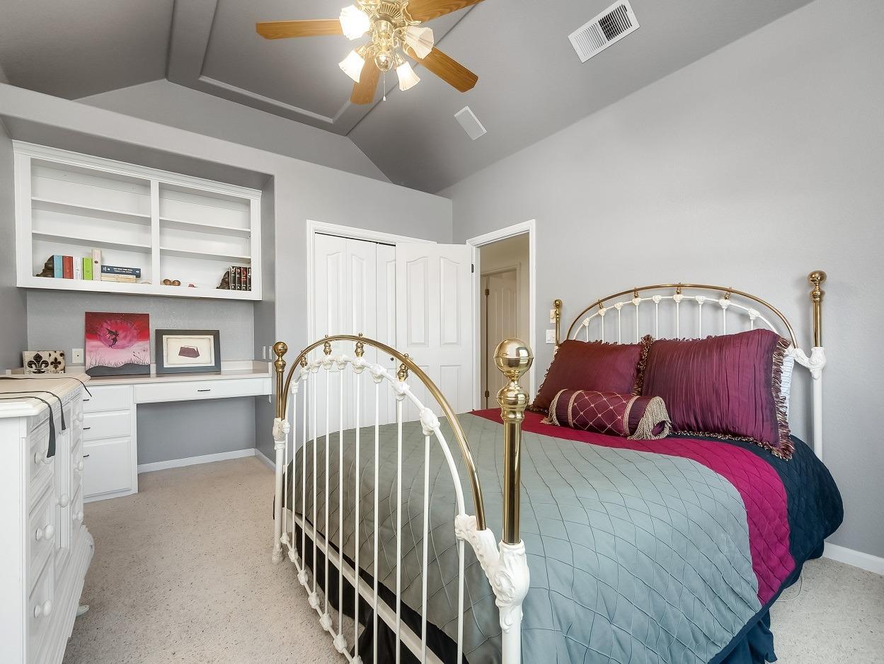 602 Fallbrook Avenue Clovis, CA 93611 - Photo 30 of 51 a bedroom with bed and a book shelf