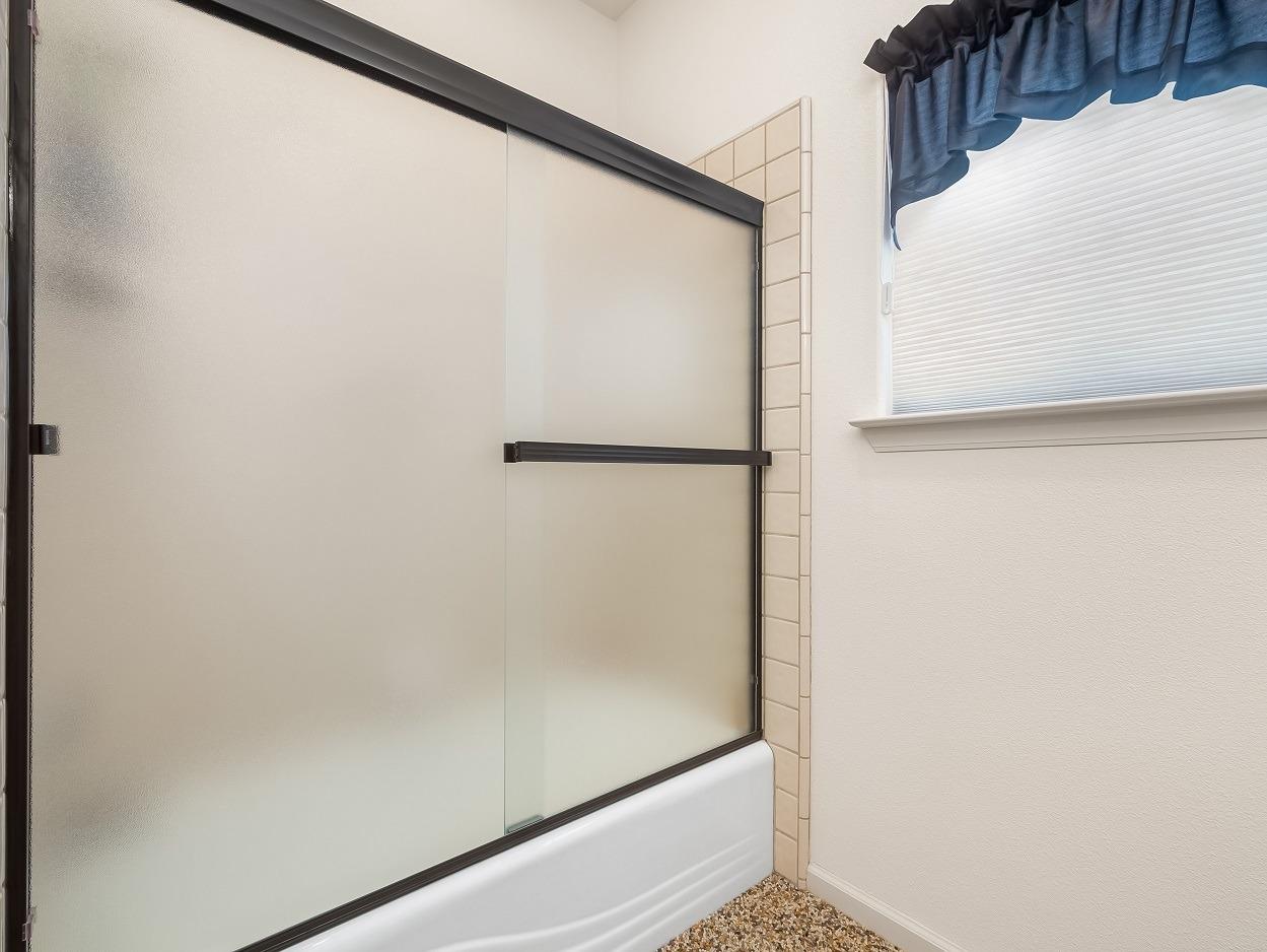602 Fallbrook Avenue Clovis, CA 93611 - Photo 36 of 51 a bathroom with a glass shower door