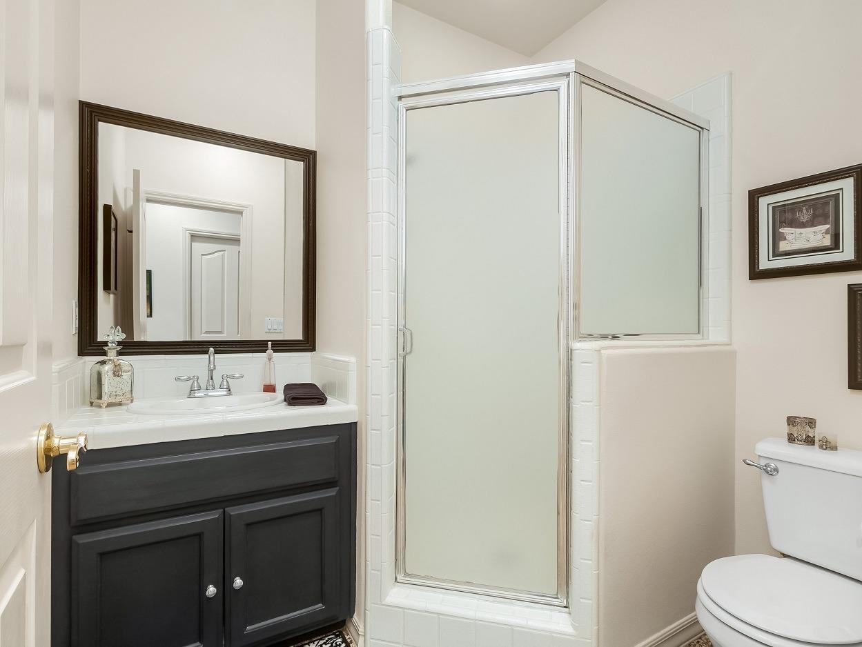 602 Fallbrook Avenue Clovis, CA 93611 - Photo 37 of 51 a bathroom with a sink vanity mirror and toilet