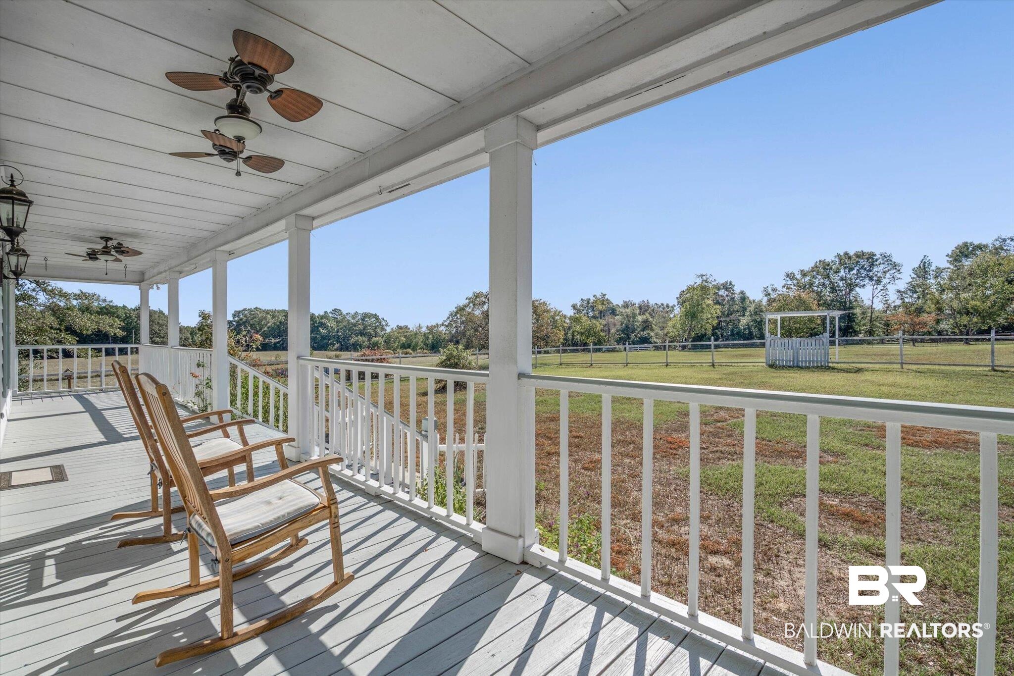 7650 Iron Rush Road Wilmer, AL 36587 - Photo 5 of 34 Deck featuring a ceiling fan and view of scattered trees