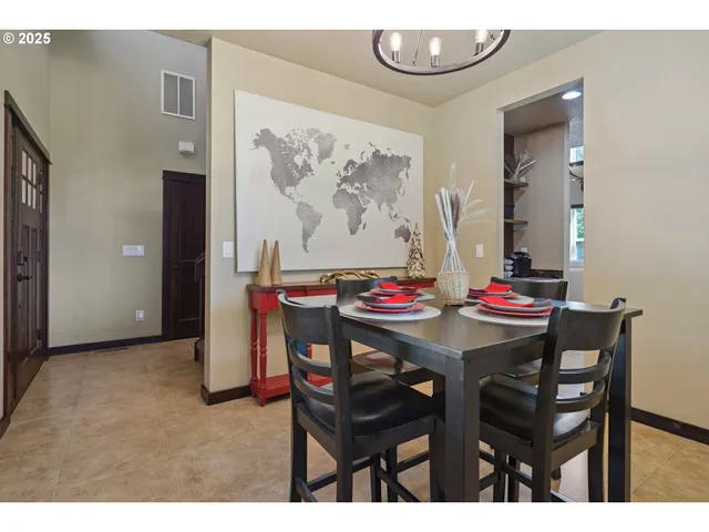 a view of a dining room with furniture and chandelier